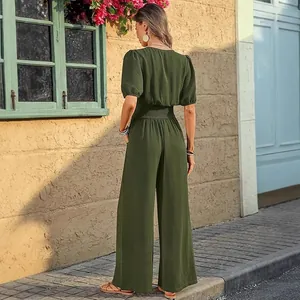 Detail view of an elegant olive green short-sleeved jumpsuit with elastic waist.