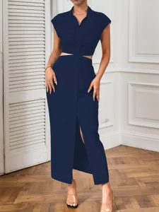 Front view of navy blue sleeveless cutout shirt dress with functional button-down design