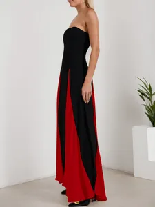 Close-up detail of a sexy black and red color-block strapless maxi dress evening gown for women