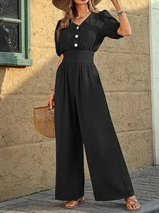 Elegant black short-sleeved jumpsuit with smocked waist and wide-leg pants detail