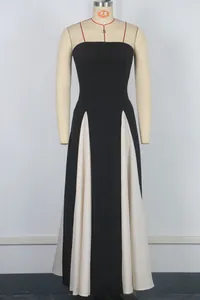 Elegant black strapless maxi dress featuring white pleated panels displayed on a mannequin
