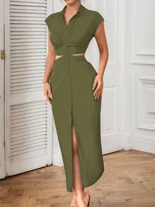 Detailed view of olive green midi dress featuring sexy waist cutout and button front.