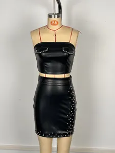 Sexy black faux leather two-piece set featuring tube top and studded mini skirt detail