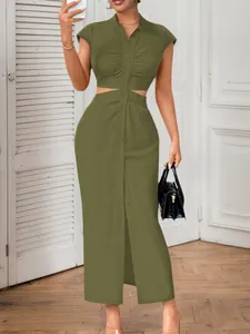 Close-up of stylish olive green dress featuring waist cut-outs and front button detail