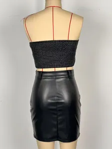 Rear view detail showing black smocked tube top paired with faux leather mini skirt set