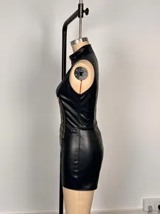 Side view of a sleeveless black faux-leather bodycon mini dress on a mannequin.