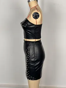 Side detail view of a black faux leather two-piece set featuring silver studs decoration