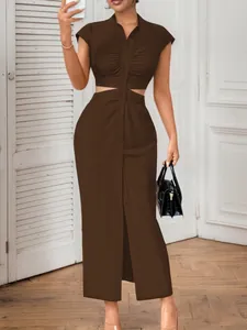 Detail of a sexy brown cutout maxi dress featuring a stand collar and button-down front design
