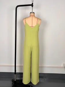 Back view of a minimalist green camisole jumpsuit with wide leg and V-neck design.