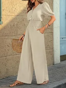 Elegant beige short-sleeve wide-leg jumpsuit with elastic waist in a street style setting