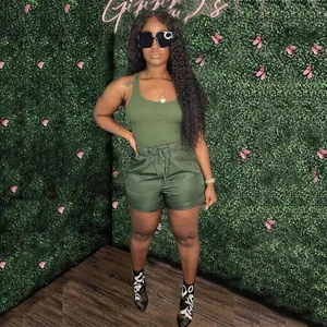 Fashionable woman wearing olive green two-piece set with tank top and casual shorts