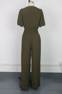 Rear view of an olive green short sleeve jumpsuit featuring a smocked waistline