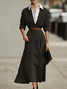 Dettaglio di un abito midi vintage gessato con colletto bianco e cintura marrone