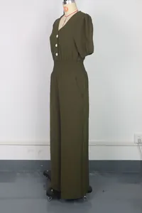 Detailed side view of an olive green wide leg jumpsuit with short sleeves and smocked waist