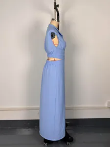 Detailed side view of a light blue sleeveless cutout waist maxi dress in textured fabric