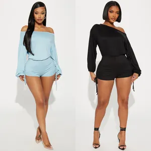 Detailed view of women's off-shoulder long sleeve ruched drawstring romper in blue and black