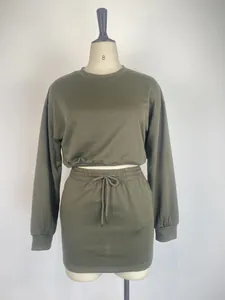 Women's olive green two-piece set featuring long sleeve crew neck top and mini skirt