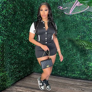Sporty black and white buttoned romper jumpsuit featuring white short sleeves and slim fit design