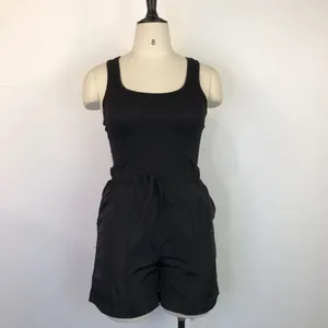 Detail of black racerback tank top and casual loose shorts two-piece summer set.