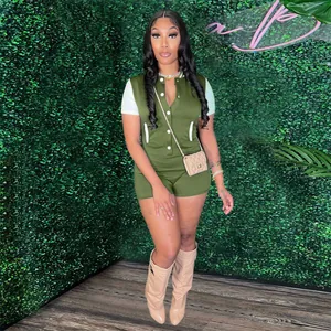 Fashionable olive green button-up romper jumpsuit with white short sleeves on model