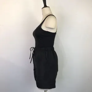 Side view of black racerback tank top and drawstring casual shorts set on a mannequin
