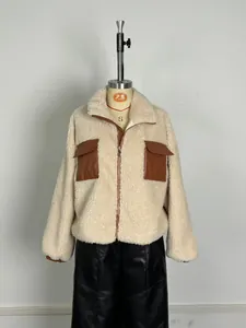 Detail view of fleece jacket featuring brown PU leather patchwork pockets and zipper