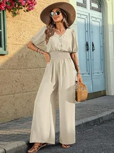 Elegant beige short sleeve wide-leg jumpsuit with a gathered waist and button-down front