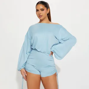 Detail view of light blue off-the-shoulder long sleeve ruched romper with drawstring