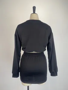 Detail view showing the back of the black long sleeve top and skirt set on mannequin