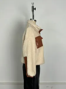 Side view of women's cream sherpa jacket with brown PU leather patchwork details