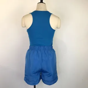 Back view of blue racerback tank top and matching loose shorts athletic set on a mannequin