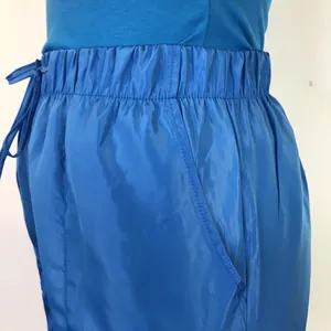 Detailed view of blue casual shorts featuring elastic waistband and side pocket texture