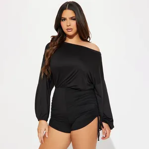 Detail showing the side ruching and drawstring on a black off-the-shoulder romper suit