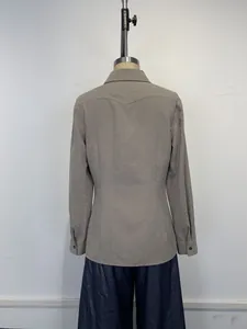 Detailed back view of a vintage long-sleeved taupe shirt with a distressed texture