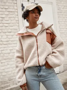 Trendy women's beige faux shearling fleece jacket with brown PU leather patchwork details