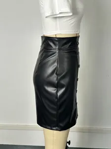 Side view of black PU leather bodycon skirt featuring double-breasted button detail