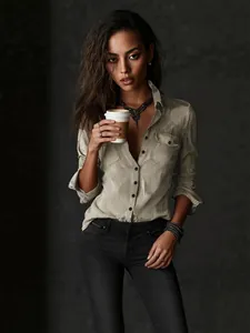 Vintage distressed long-sleeve button-up shirt with lapel and pockets for women.