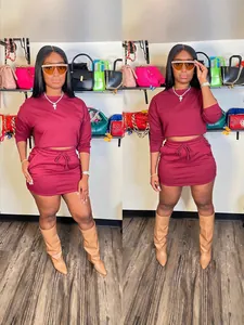 Trendy burgundy two-piece set with long sleeve crop top and drawstring mini skirt