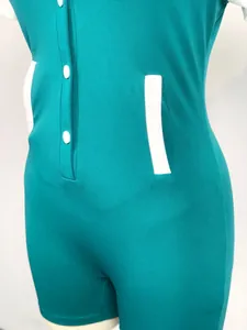 Close-up detail of teal slim-fit romper featuring white buttons and contrast pocket trim