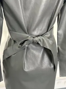 Detail view showing the tied waist belt on a stylish grey PU leather dress for women