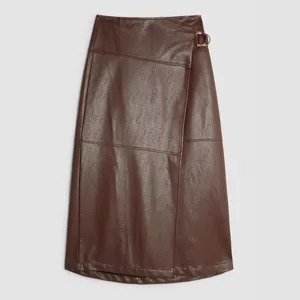 Detailed flat lay of a brown PU leather A-line skirt with an asymmetric split design