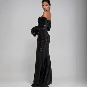 Long black lace evening gown with off-the-shoulder neckline and elegant bell sleeves.