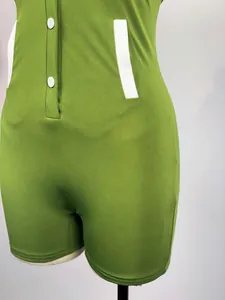 Close-up of green buttoned bodysuit showing fabric texture and white accents