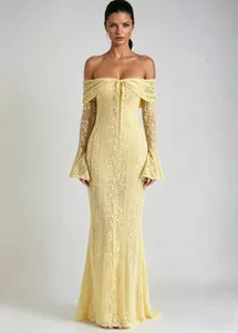 Full-length view showing the intricate lace detail and elegant fit of this yellow evening gown