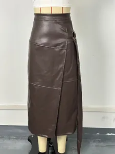 Detail view of brown faux leather skirt with adjustable belt and irregular slit