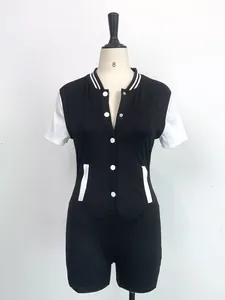 Detail view of a black and white button-down short-sleeved athletic style bodysuit