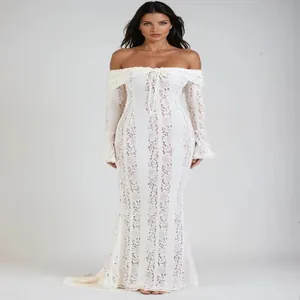 Elegant white lace off-the-shoulder mermaid dress with bell sleeves and bow detail.