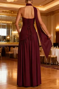 Detailed back view of a burgundy backless halter gown with corset lace-up and sash