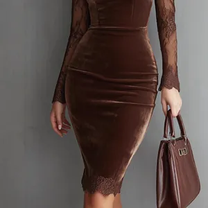 Detail view of a brown velvet bodycon dress with lace long sleeves and hem trim