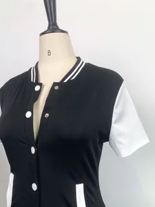 Close-up detail of a women's black and white baseball style bodysuit with buttons